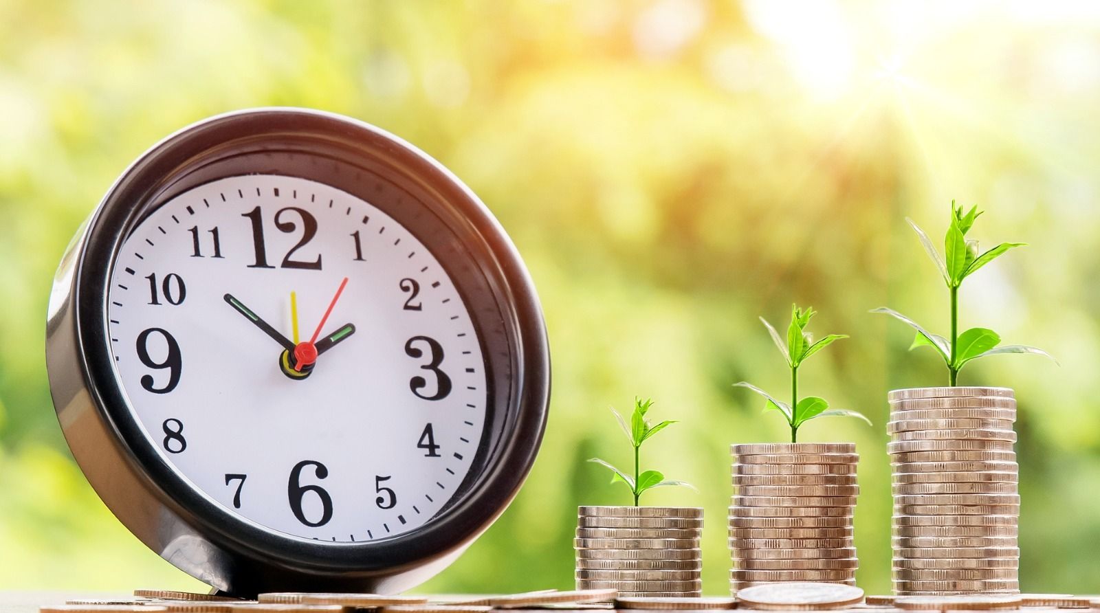 Picture of a clock and stacks of coins