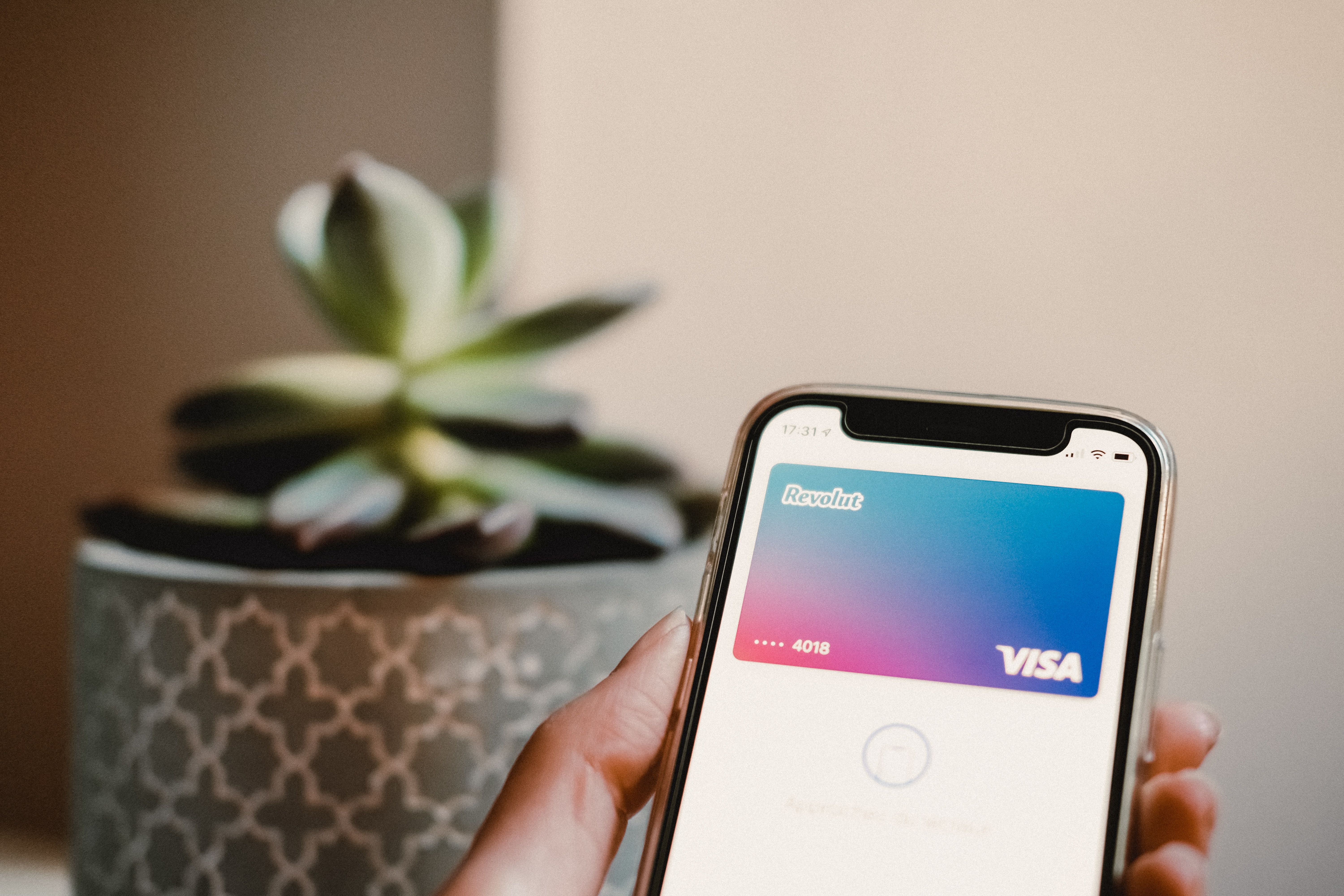 New credit card next to a smartphone showing the online card activation process