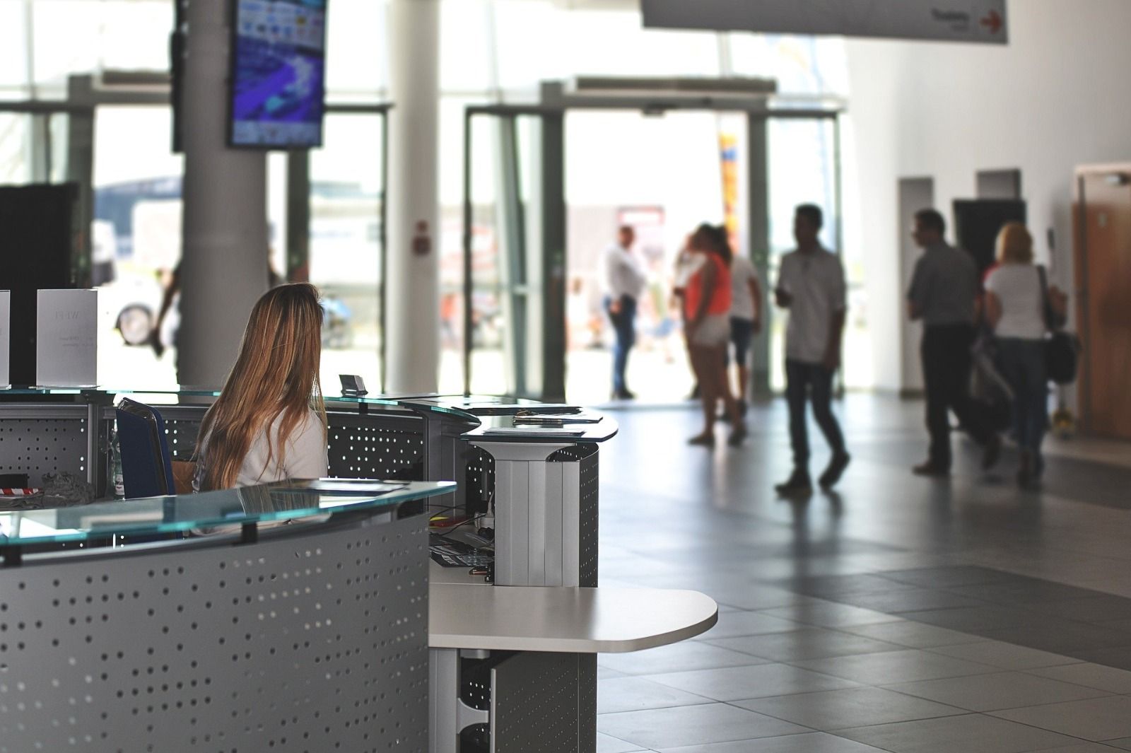 Stranded airline passengers waiting at an airport gate after a flight cancellation